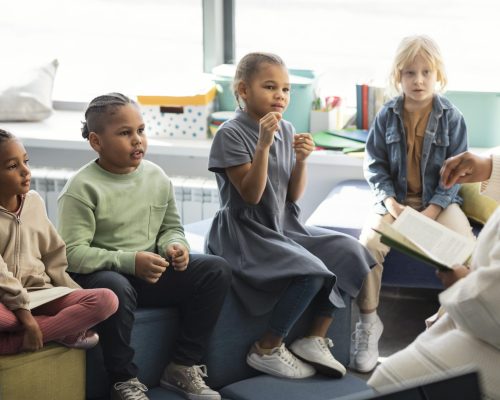 female-teacher-reading-her-pupils